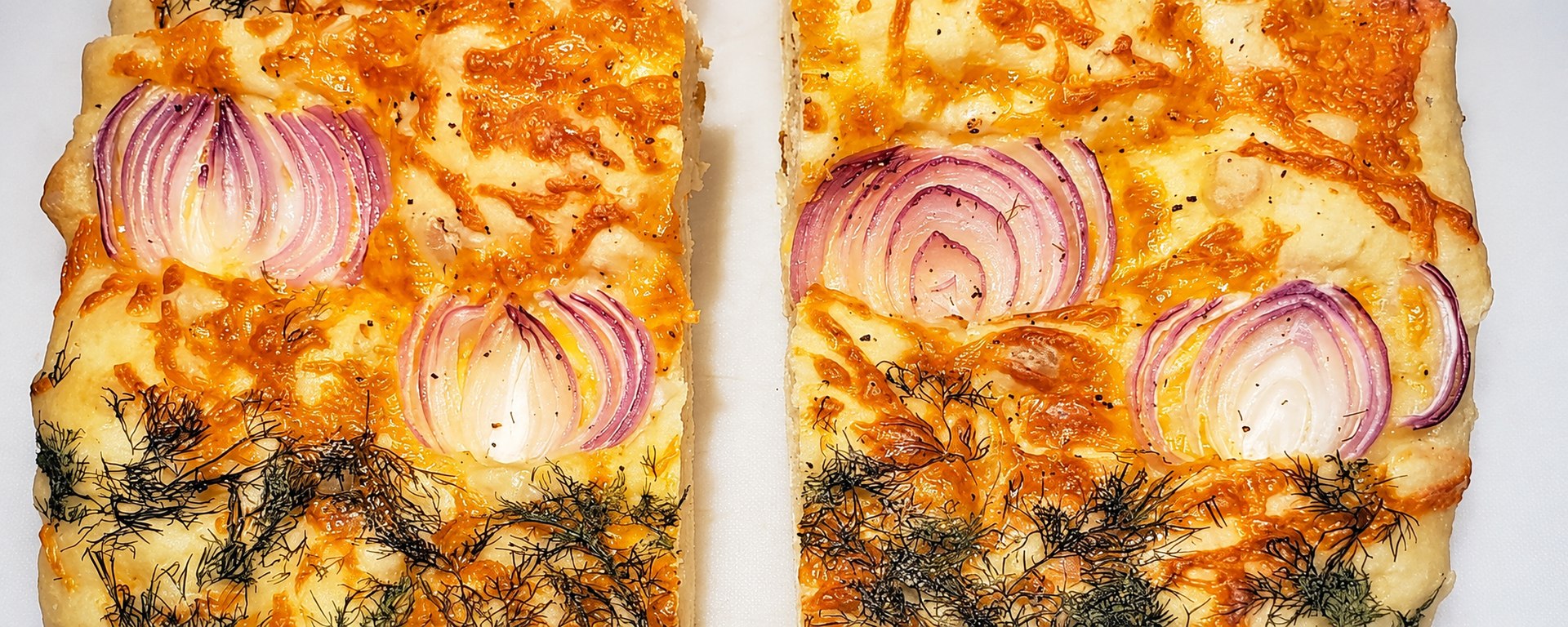 Focaccia topped with cheese, red onion and dill.